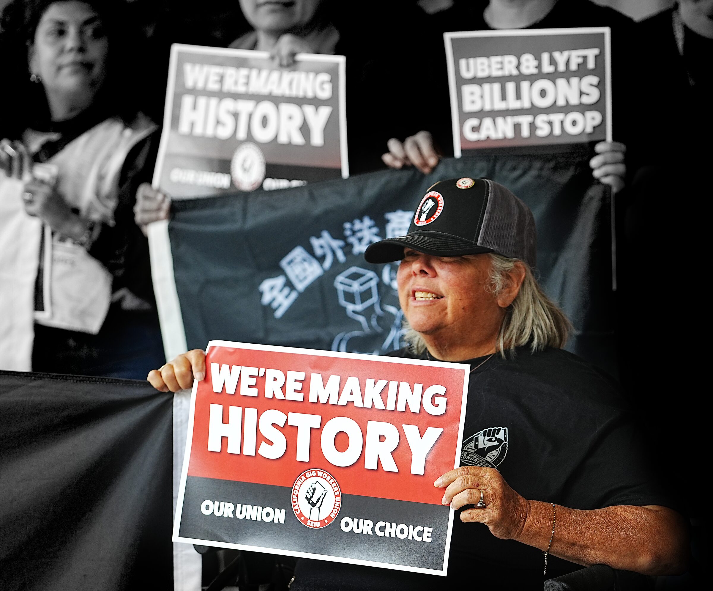 A gig driver in a CGWU Making History cap