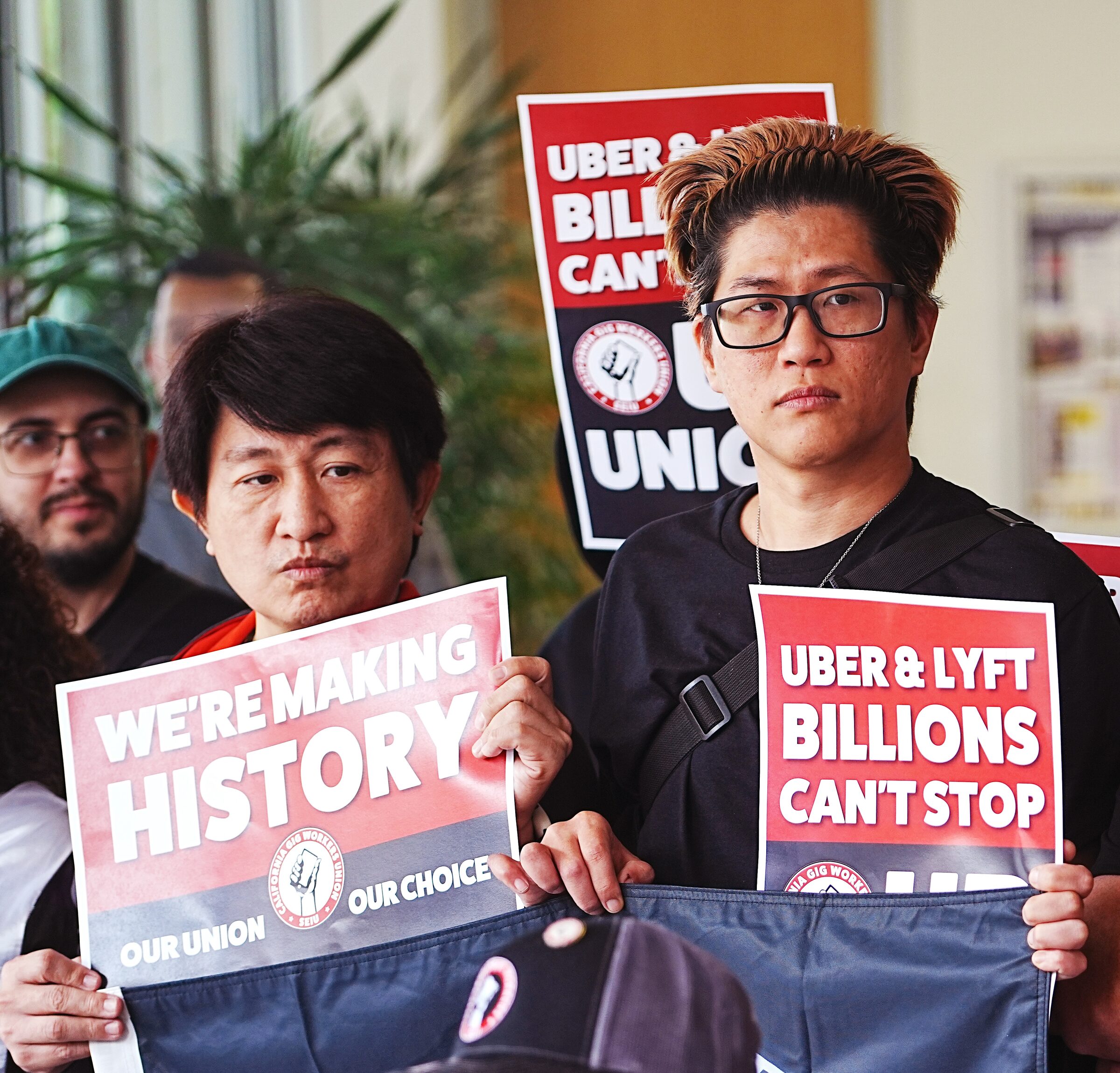 Drivers with We're Making History signs at a press conference
