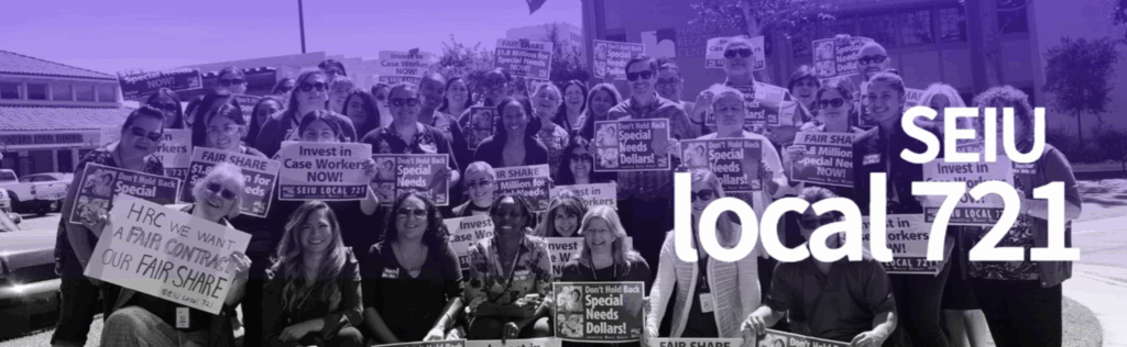 Harbor Regional Center staff gather for a group photo holding signs that ask for more dollars for special needs clients.