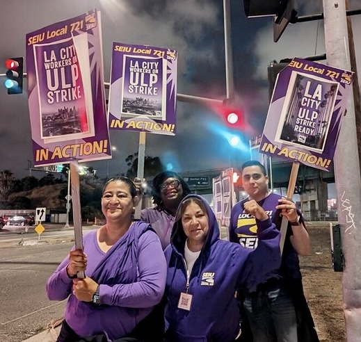 LAX workers who are members of SEIU 721 picket outside the airport with signs indicating they are ready to go on a ULP Strike.