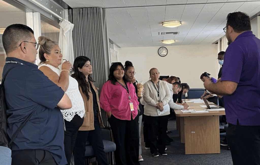 Court workers gather around and listen to SEIU 721 worksite organizer.